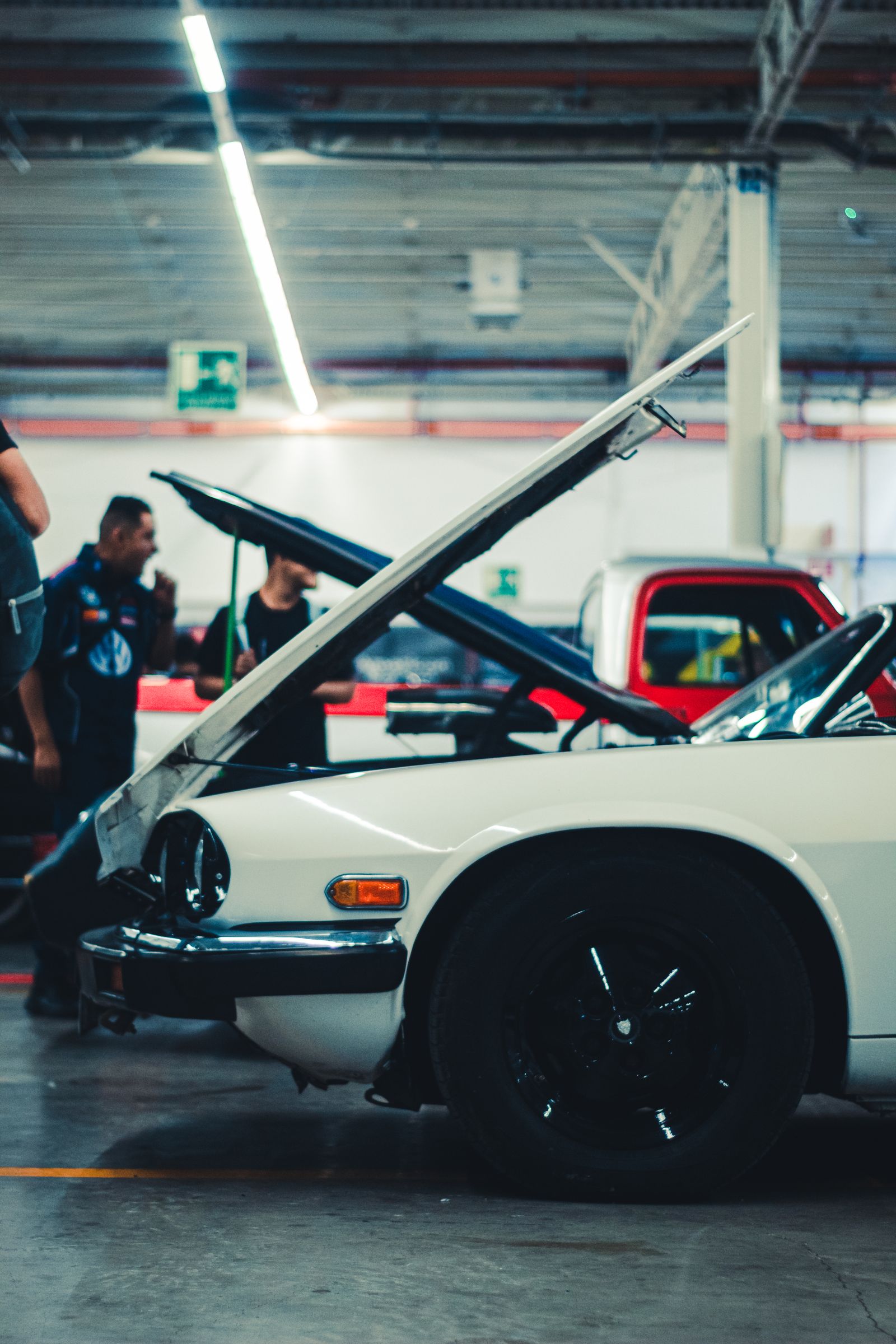 Auto mechanic with customer at car