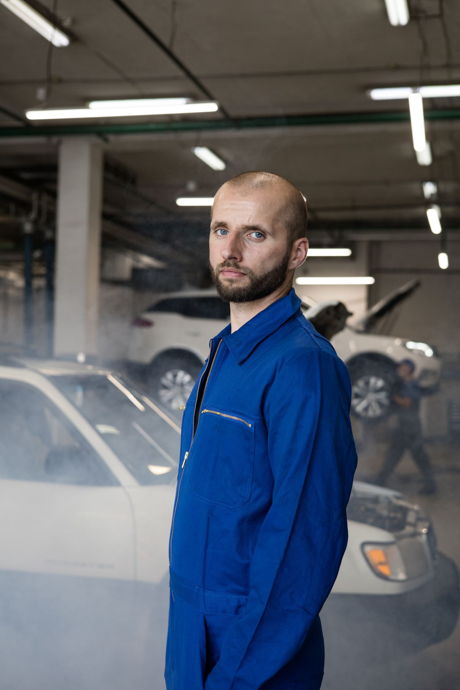 Auto mechanic with customer at car