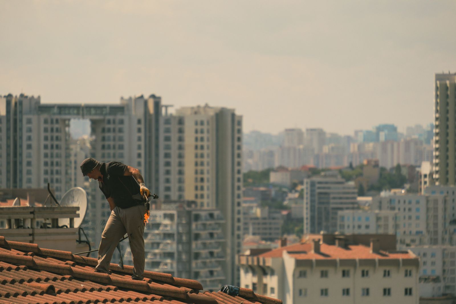 Rooftop construction worker in istanbul skyline