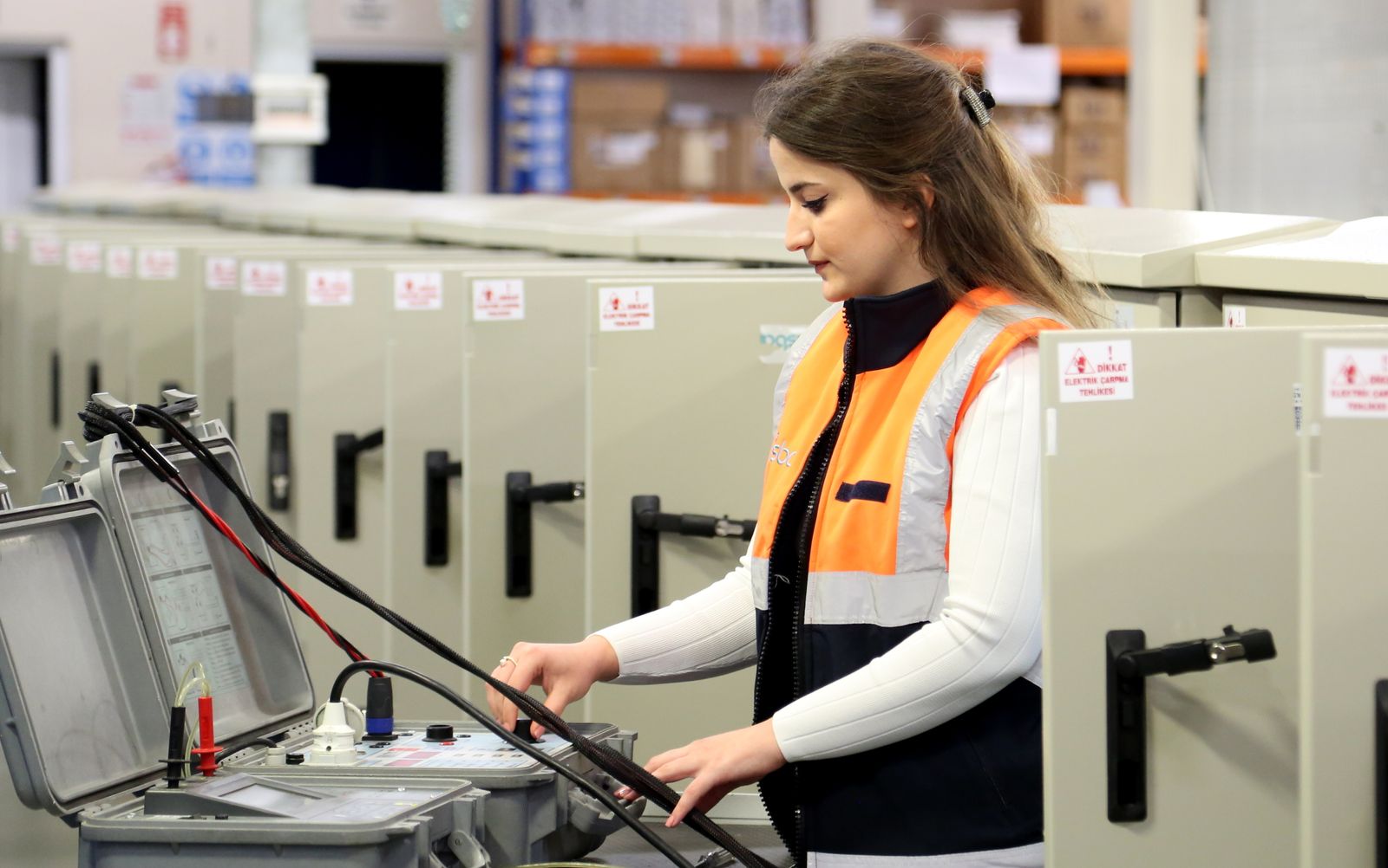 Woman working with electrical equipment