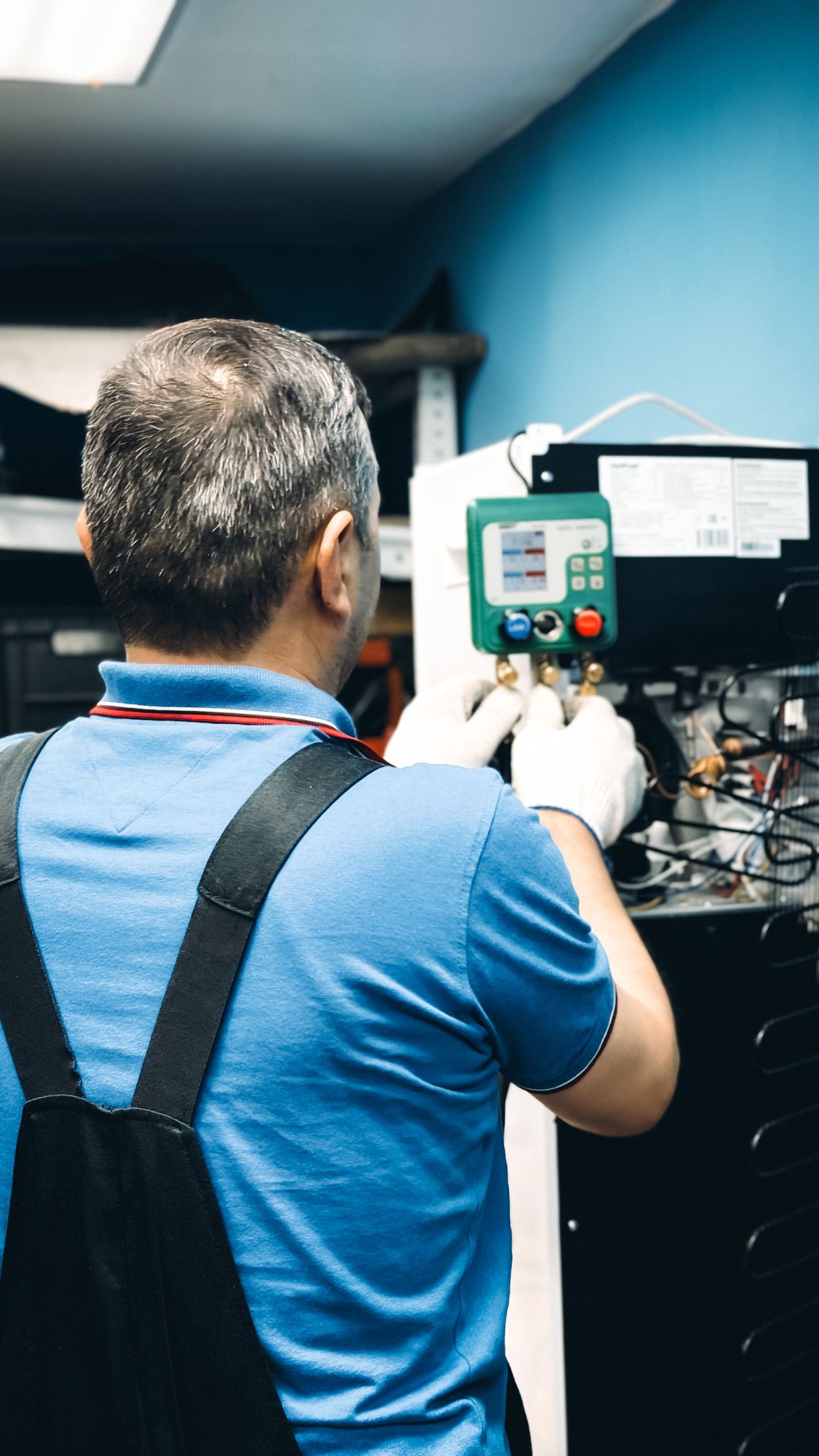A skilled technician working on air conditioning system maintenance indoors