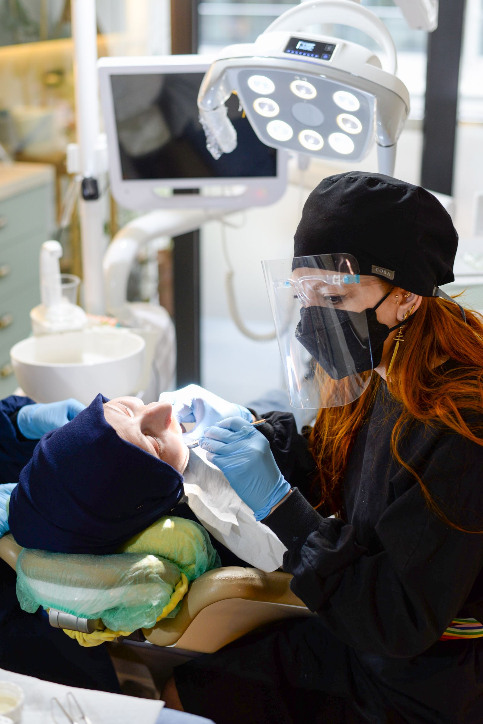 A dentist examining a patient at a dental clinic