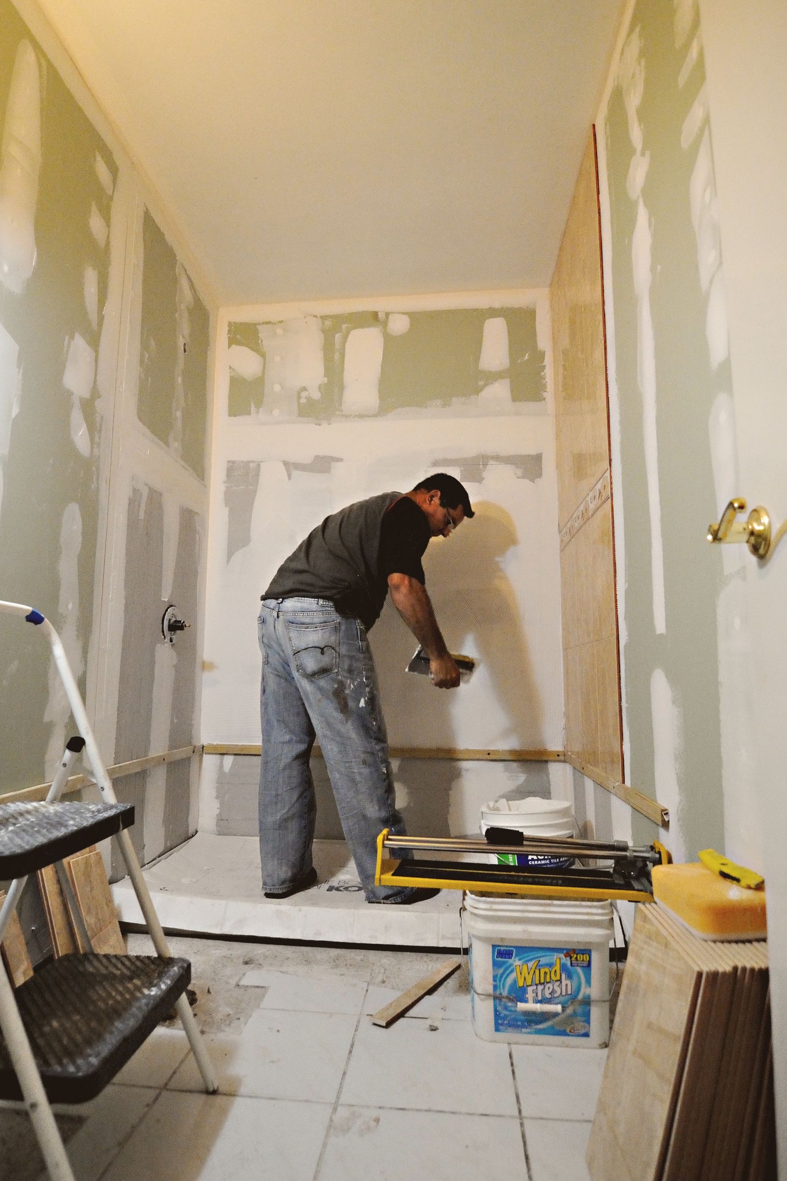 Home renovation man installing drywall in bathroom