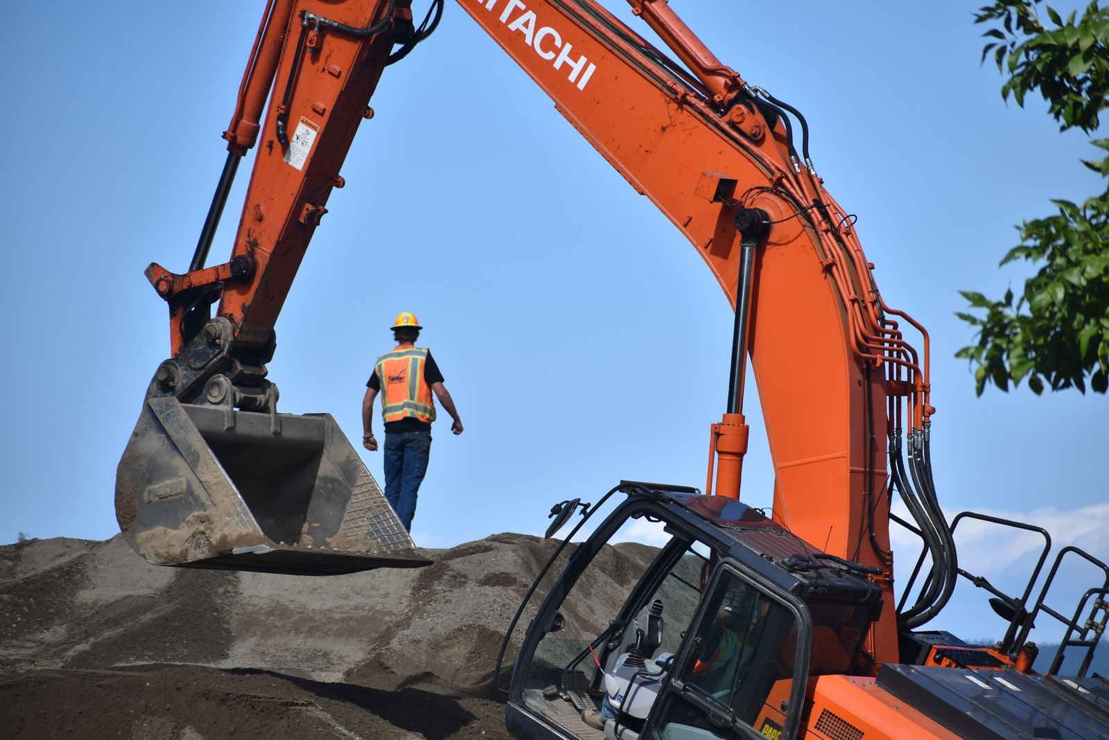 Construction worker operating excavator outdoors