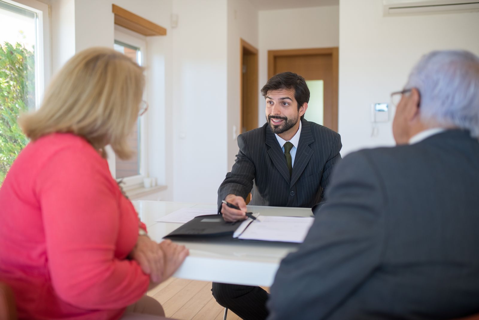 Financial advisor meeting couple at table