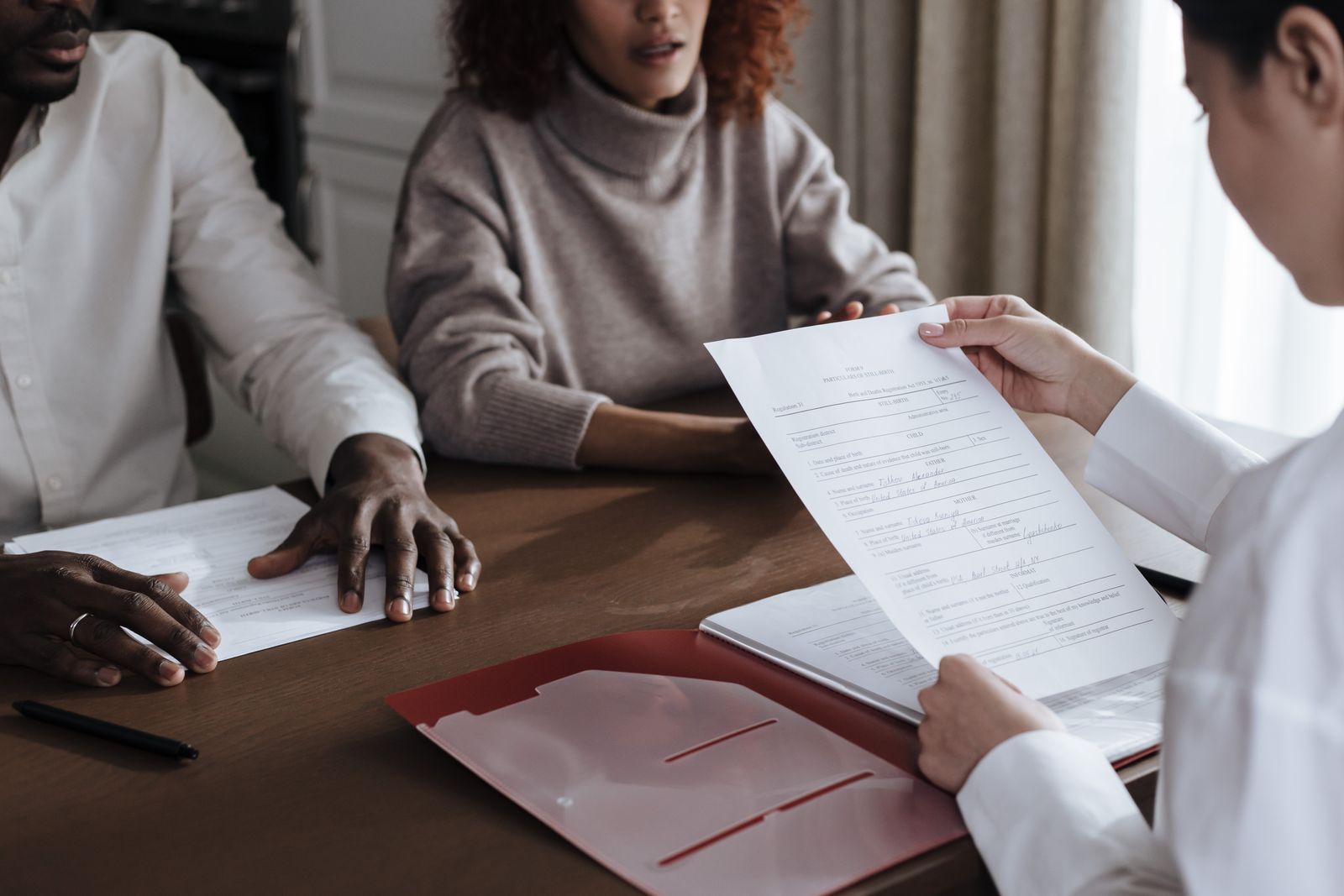 Financial advisor meeting couple at table