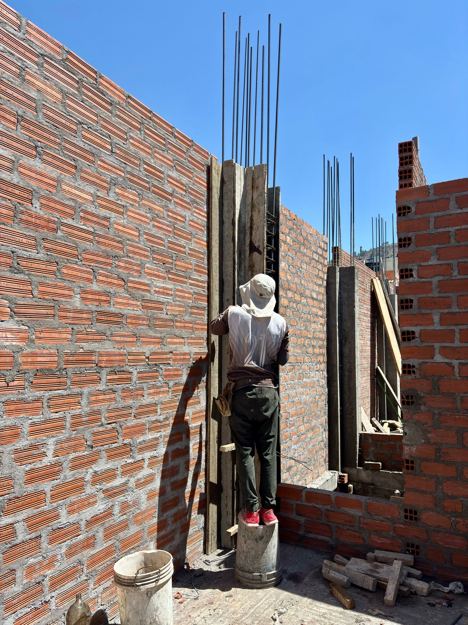 Construction worker building brick wall
