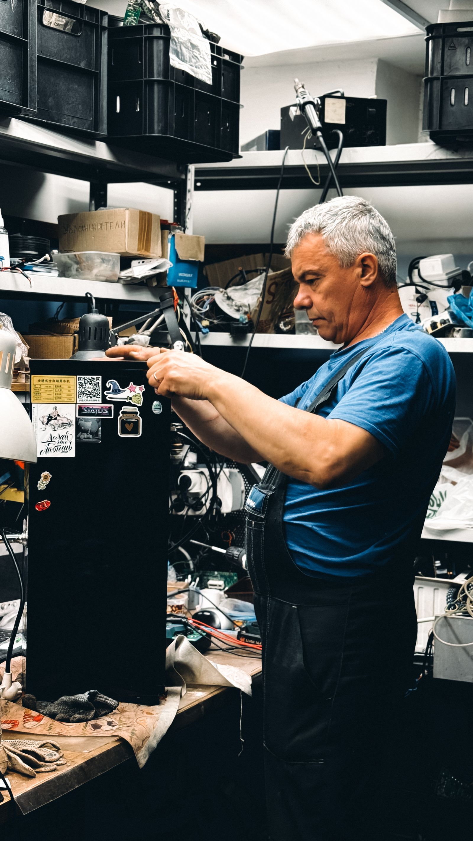 Elderly technician working in a workshop