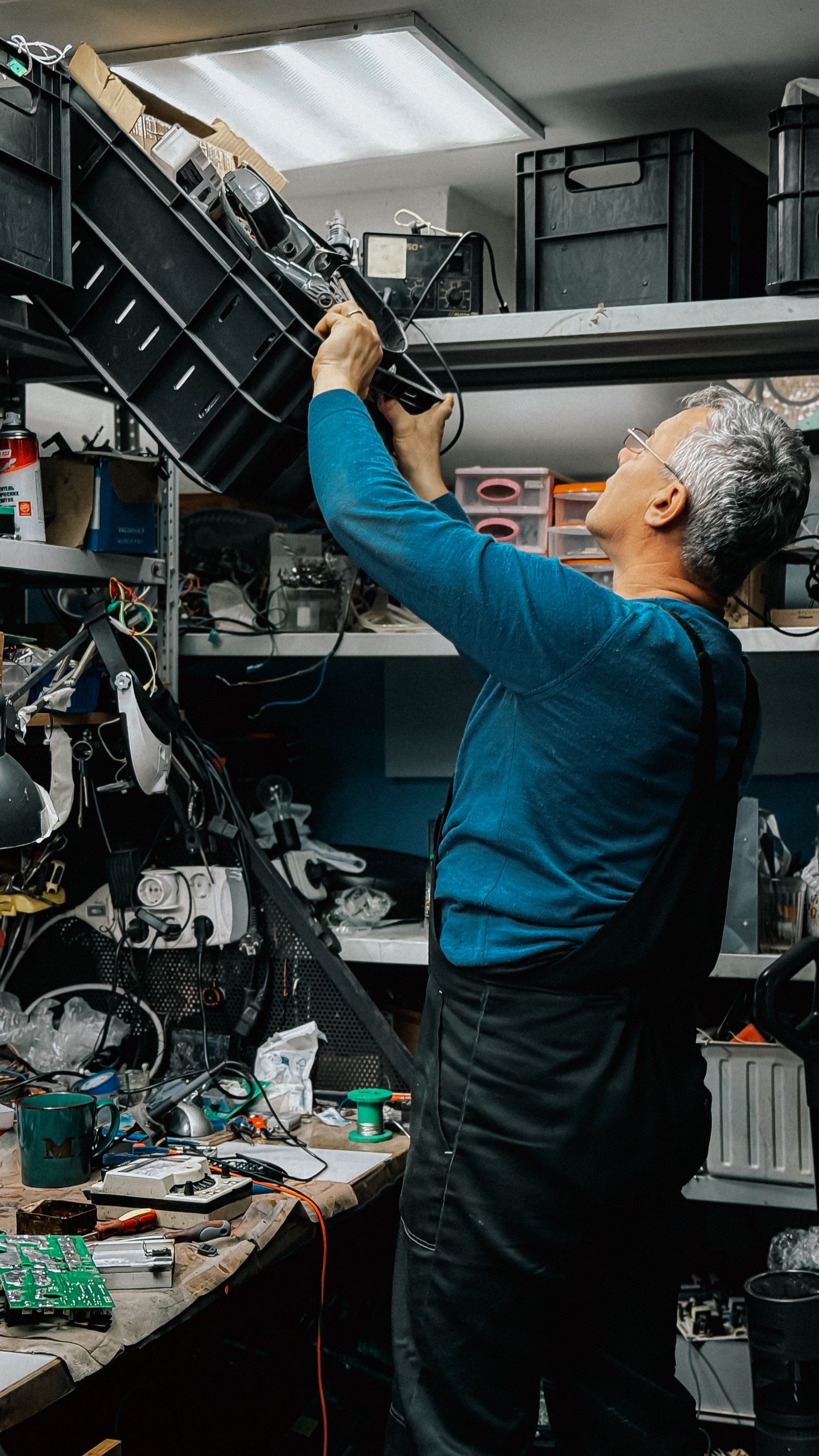 Man organizing electronic workshop components