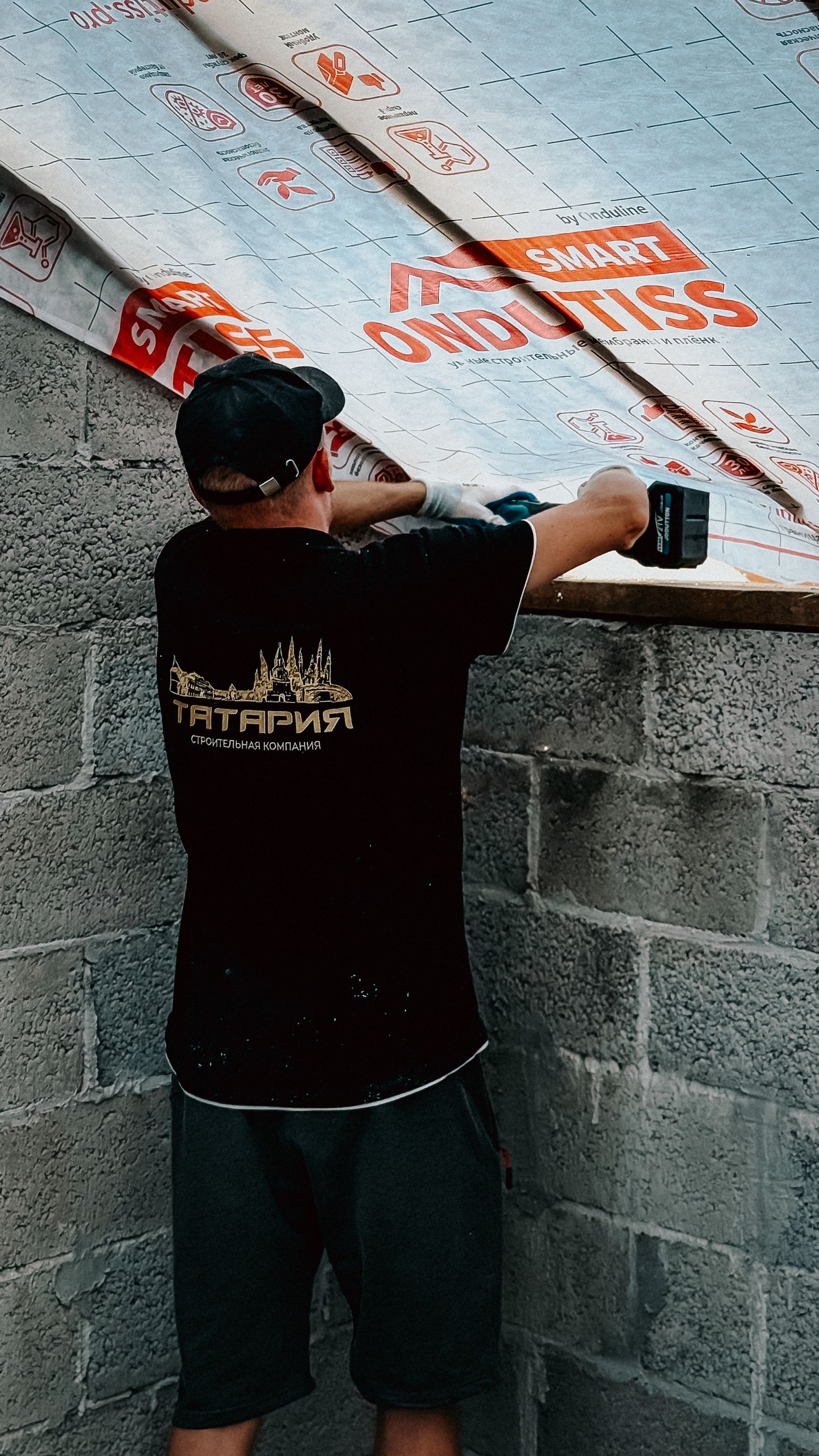 Worker installing roof insulation material