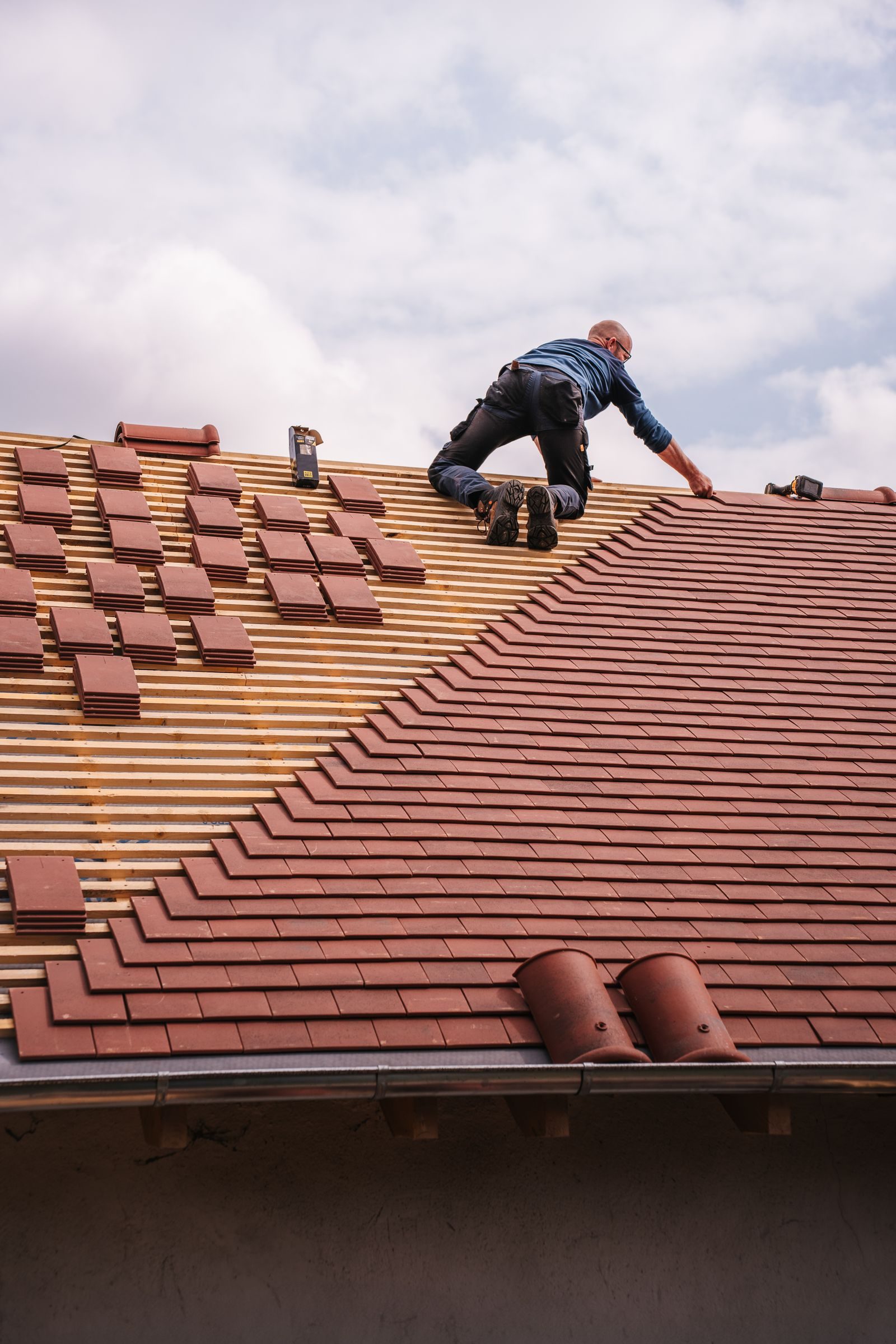Worker installing roof insulation material