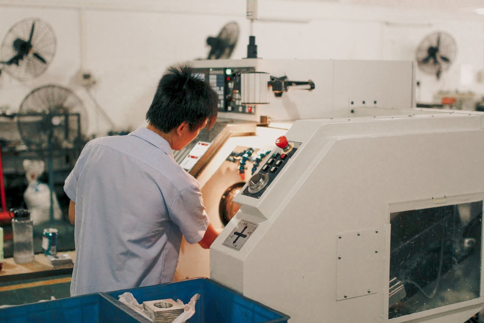 Worker focusing on operating industrial machinery in a factory setting
