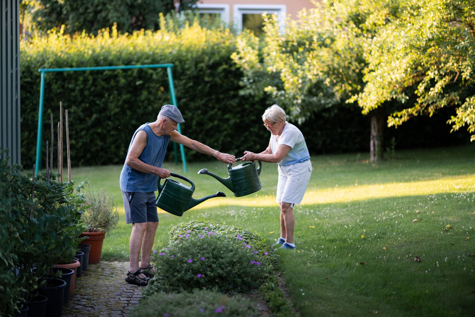 Landscaper planting garden with homeowner