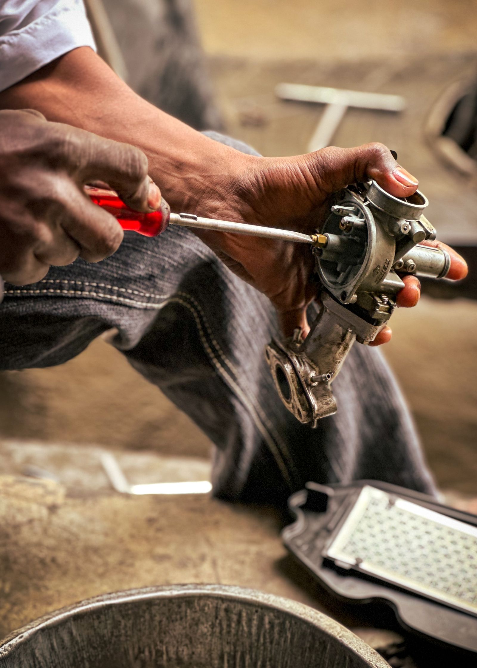 Close up of mechanic repairing carburetor