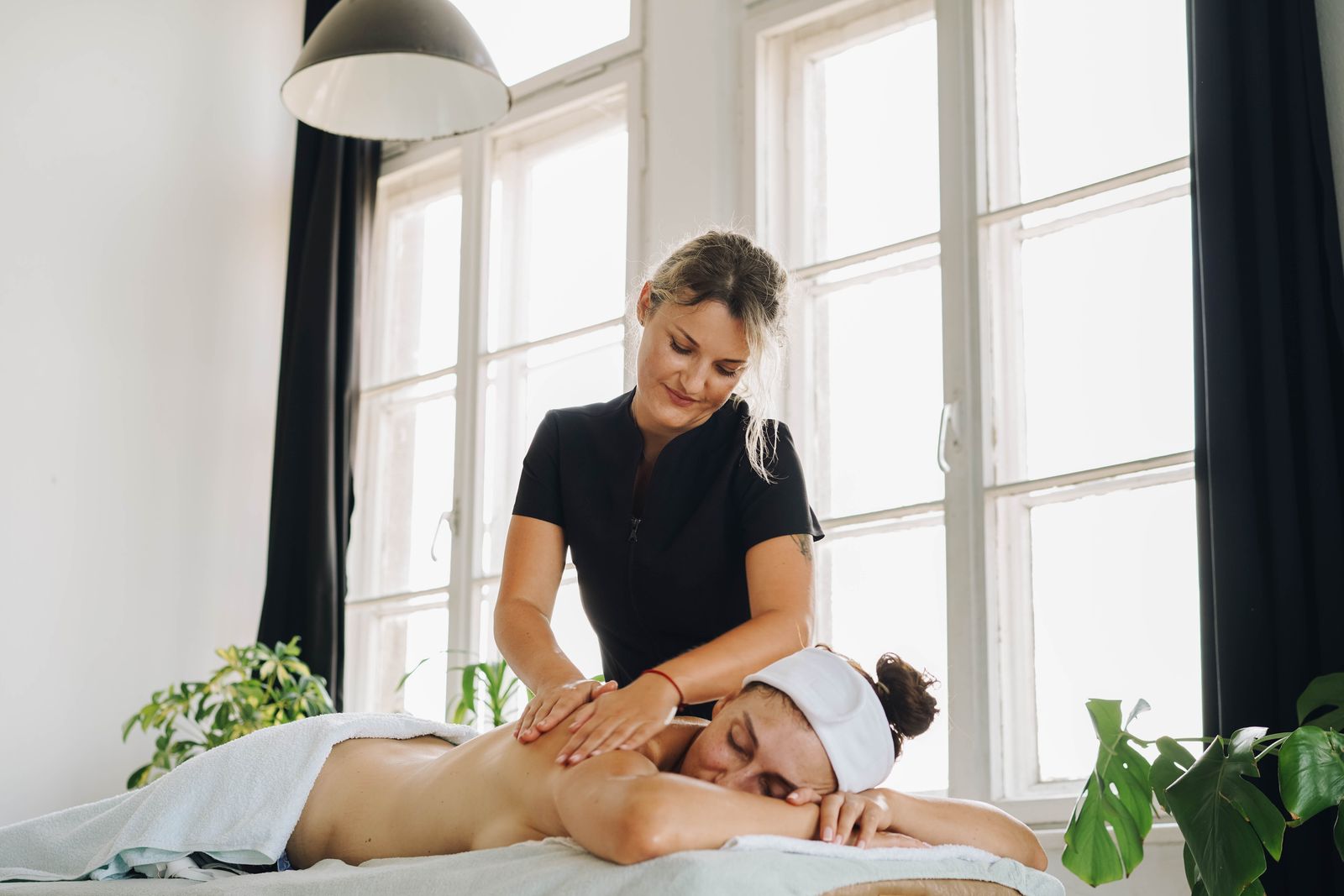 Licensed massage therapist with client