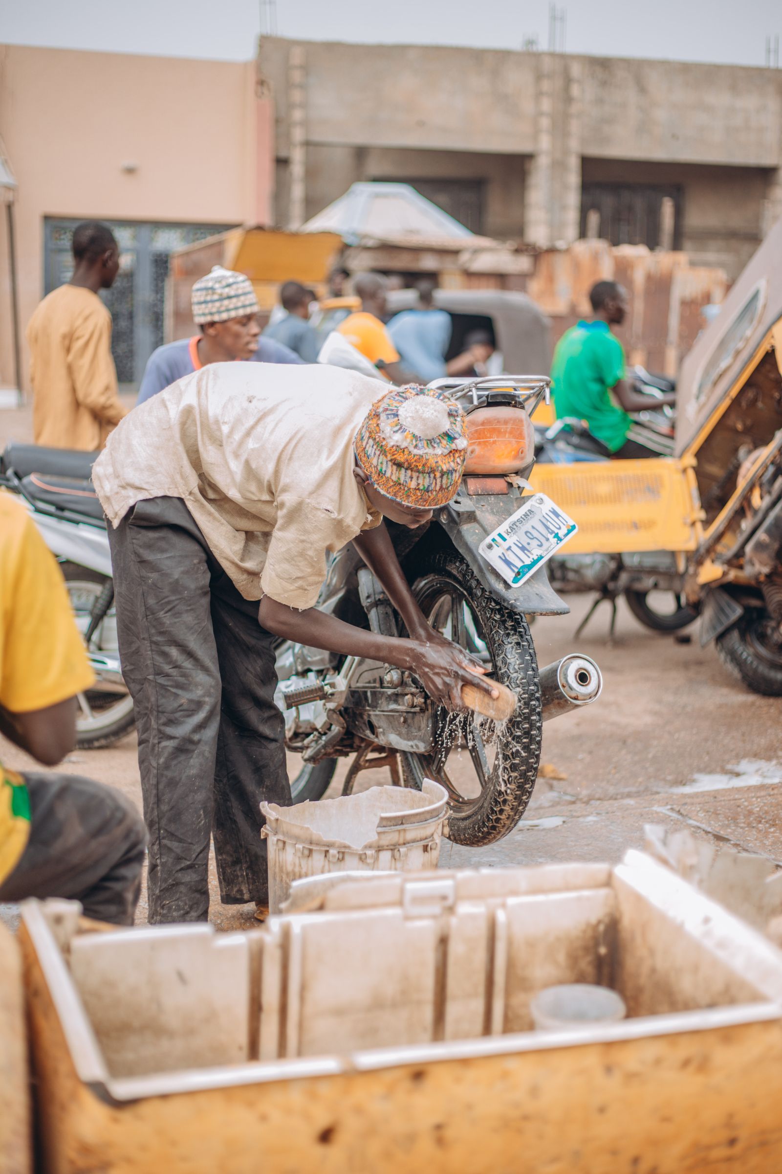 Street scene with mechanics working on motorcycles