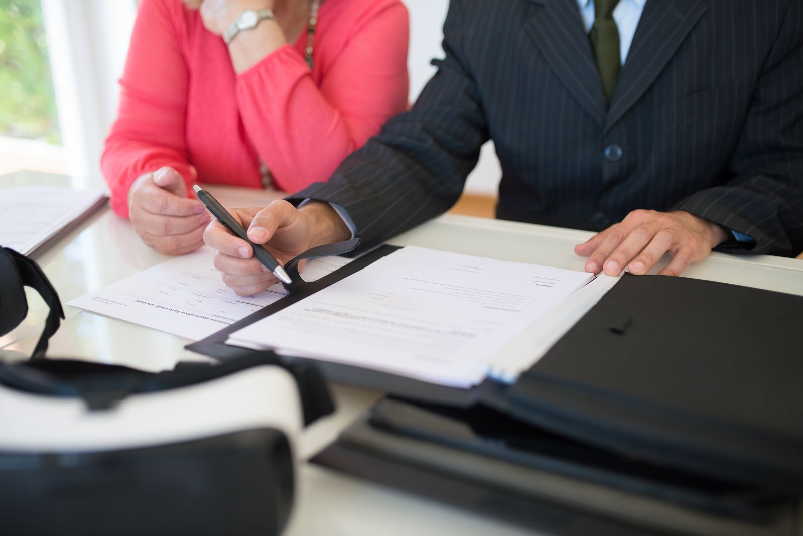 Notary signing documents with client