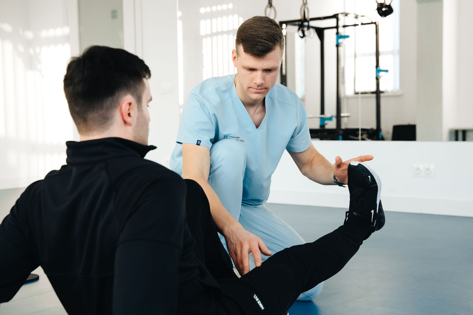 Physiotherapist examining the patients leg