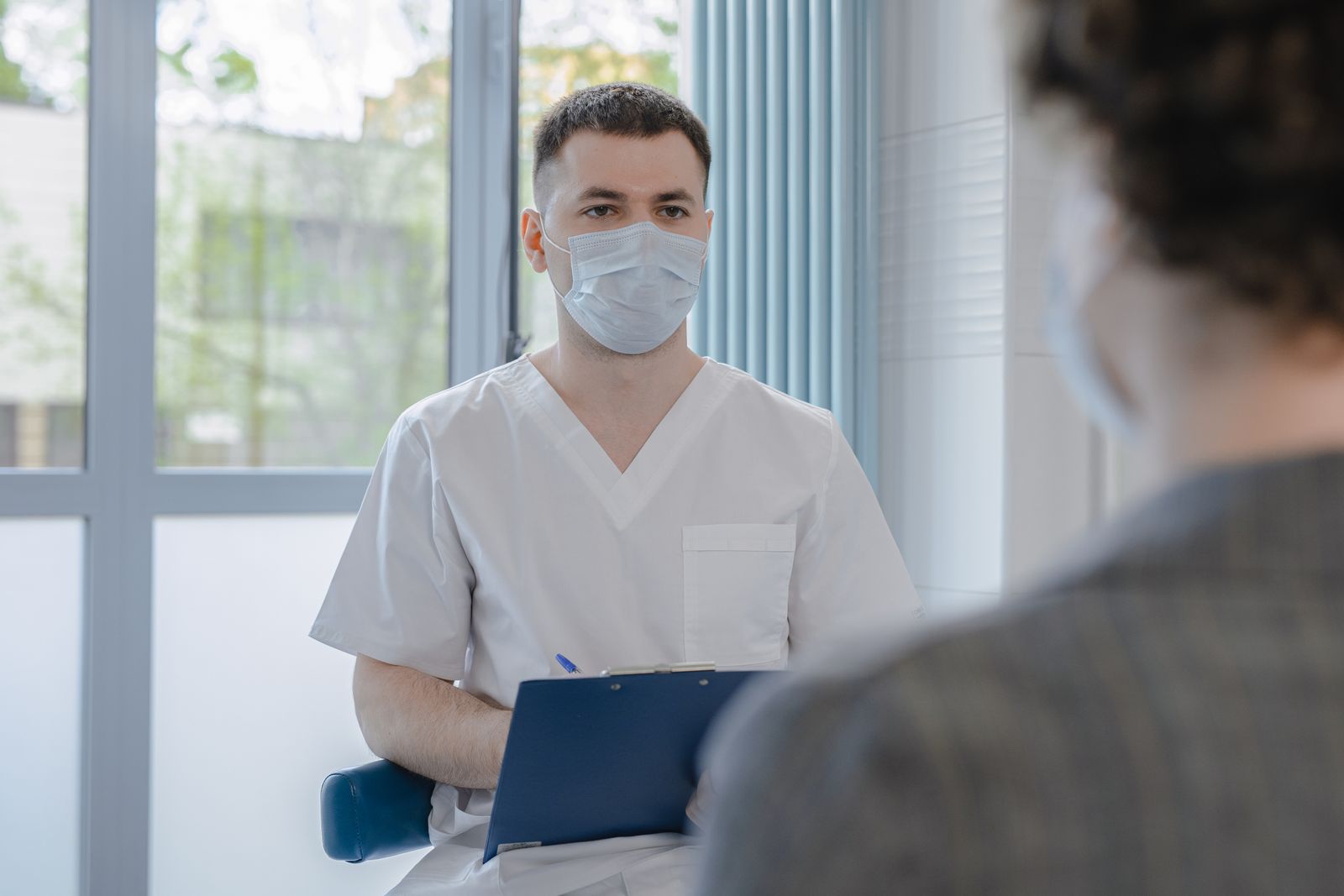 Doctor talking with patient in clinic