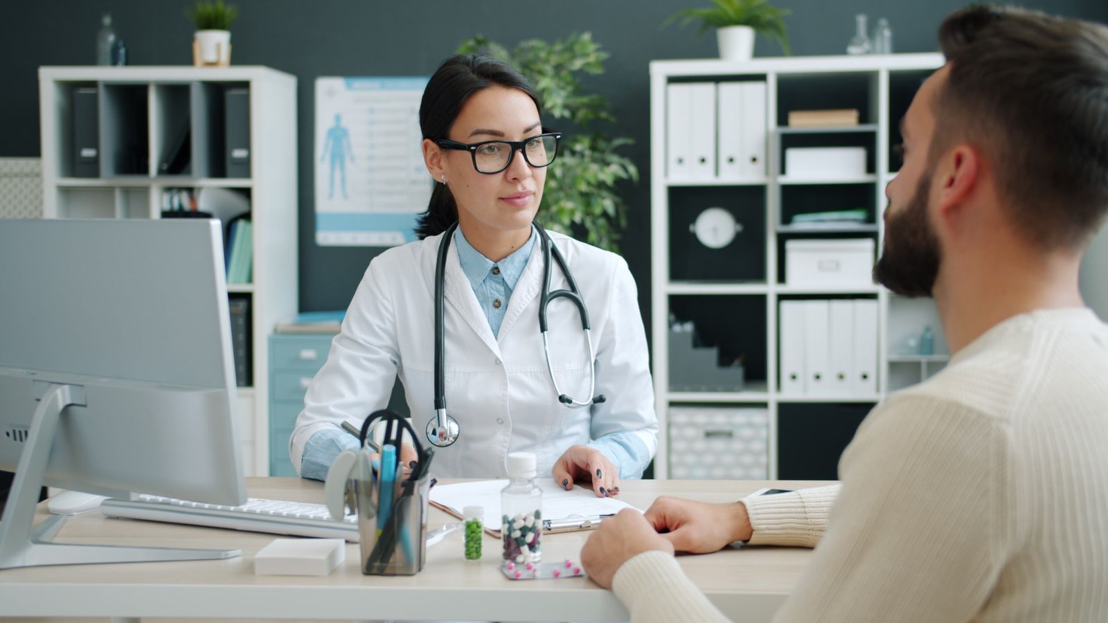 Doctor talking with patient in clinic