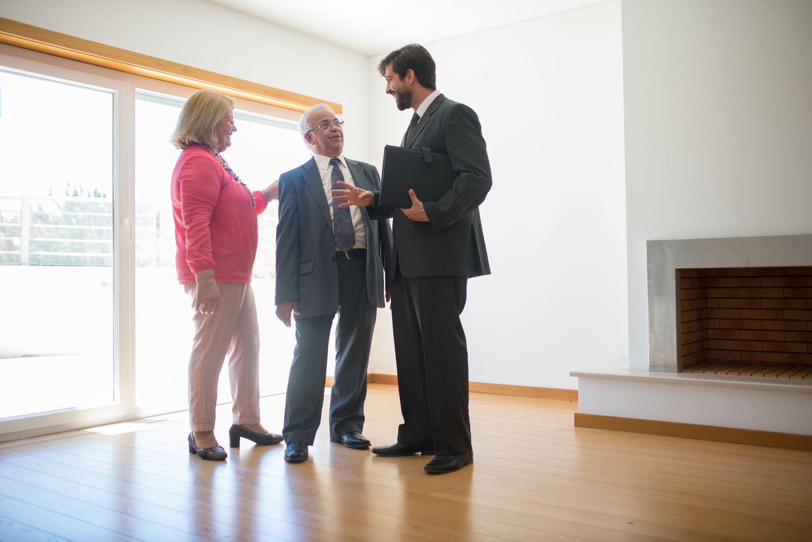Real estate agent showing house to couple
