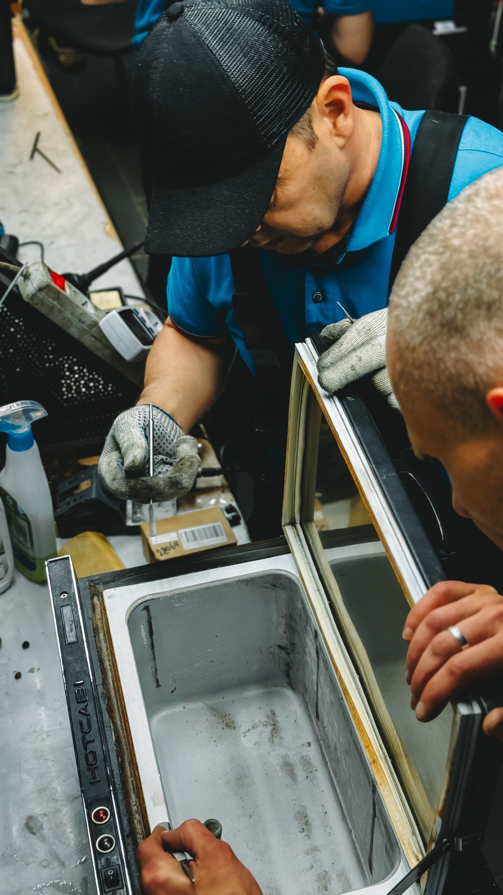 Repair technicians fixing industrial freezer