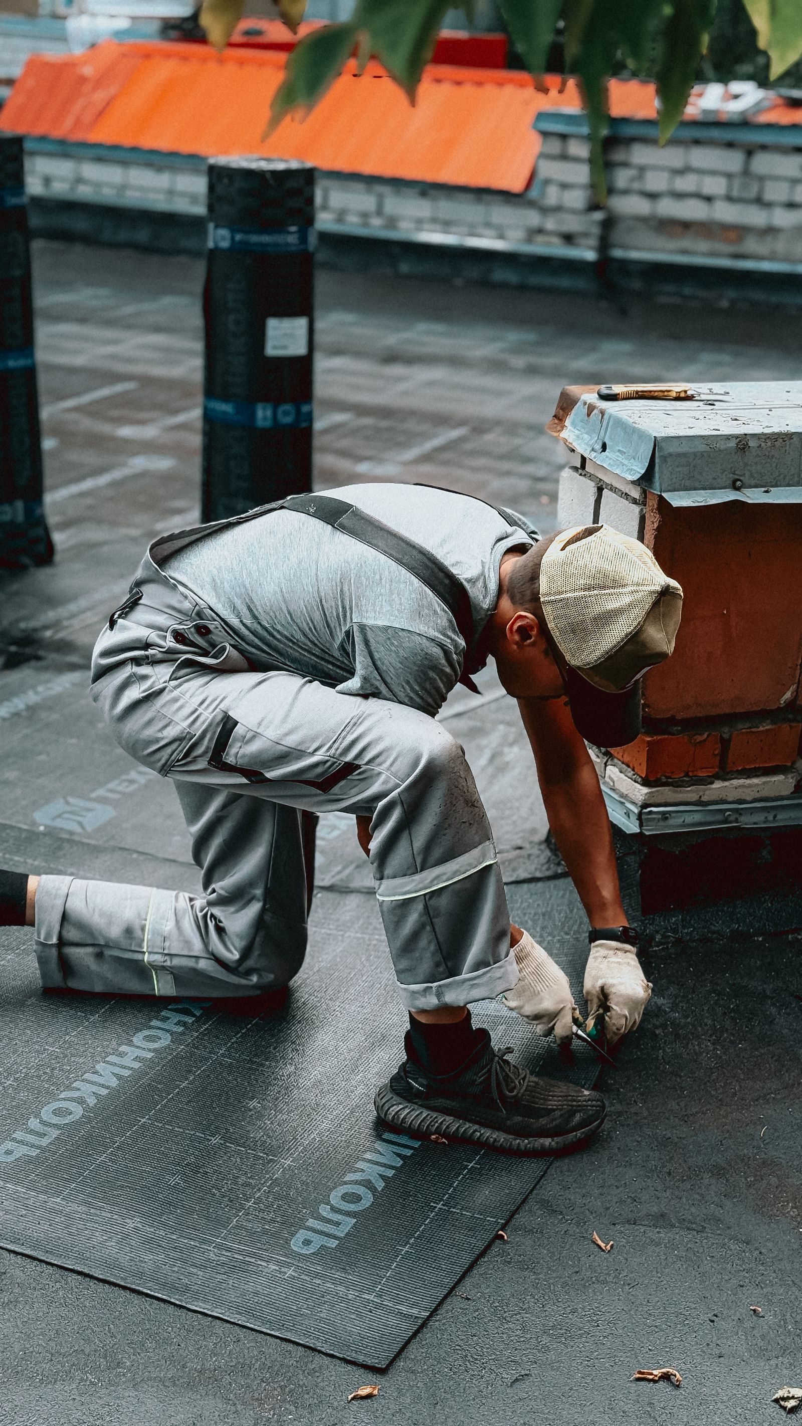 Roofer working on urban roof during daytime
