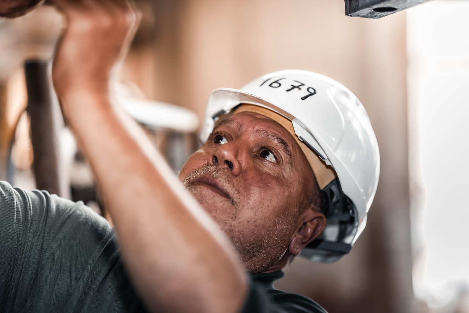 Construction worker in Libya concentrating on a task while wearing a safety helmet