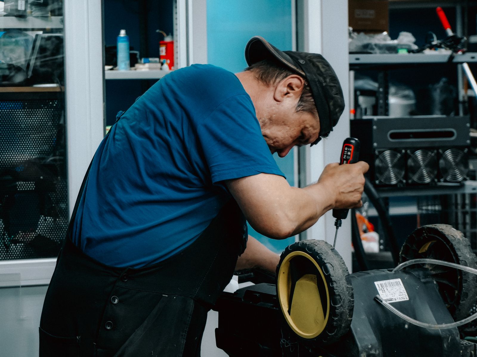 Man repairing electric toy in workshop