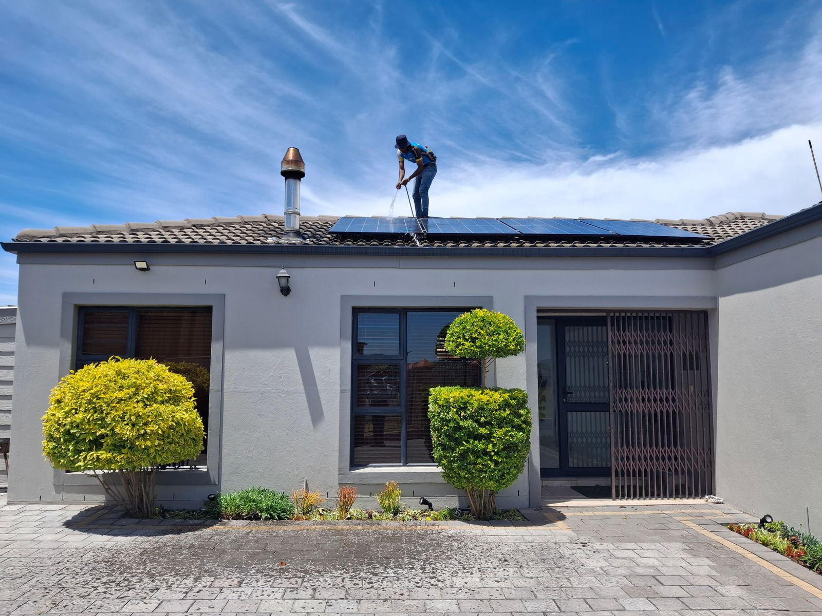 Solar panel maintenance on residential rooftop