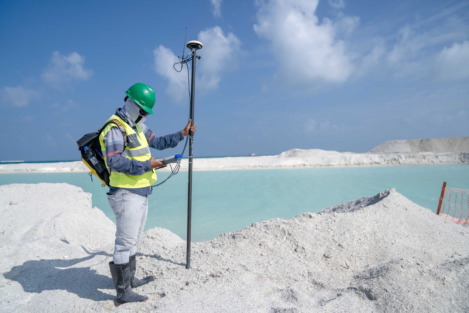 Man with measurement device by lake