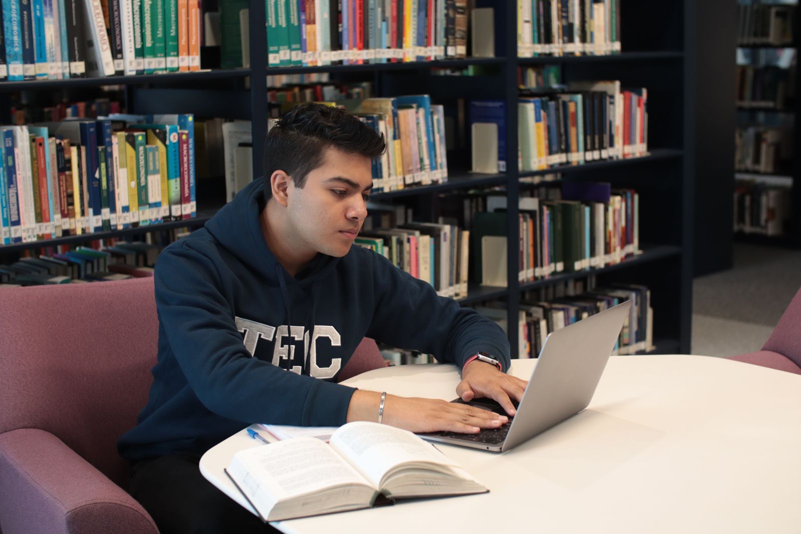Tutor teaching student at table